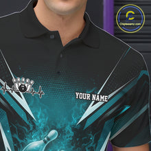 Load image into Gallery viewer, Left chest detail of a black and turquoise blue bowling polo showcasing a flaming bowling ball motif.
