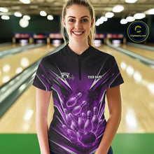 Load image into Gallery viewer, Front view female model in bowling lane wearing black and purple quarter zip shirt featuring flaming bowling ball striking pins with vivid fire action illustration.