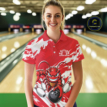 Load image into Gallery viewer, Front view of a female model in a bowling alley wearing a red custom bowling polo shirt with a fierce yet funny crawfish bowling character and a distressed background design.
