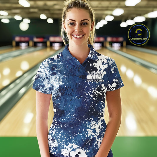 Woman wearing a blue and white bowling shirt with 'Your Name' printed on it, standing in a bowling alley.