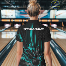 Load image into Gallery viewer, Back view of a female model in a bowling venue wearing a black and turquoise blue polo showcasing a patriotic bowling ball hitting pins design.