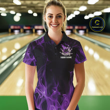 Load image into Gallery viewer, Female model at a bowling lane wearing a black and purple polo shirt featuring a dynamic bowling ball crash graphic with flames and scattered pins.