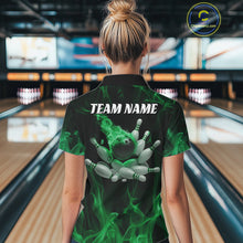 Load image into Gallery viewer, Back view of a female model in a bowling center wearing a black and green polo showcasing a bowling ball crashing through pins with flame effects.