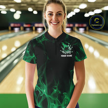 Load image into Gallery viewer, Female model at a bowling lane wearing a black and green bowling quarter-zip shirt with bowling strike artwork, scattered pins, and flame effects.
