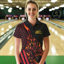 Load image into Gallery viewer, Female model at a bowling lane wearing a black bowling polo shirt with red-orange flame bowling strike artwork and patriotic graphics.