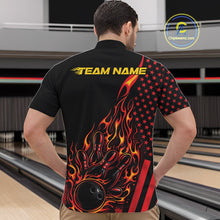 Load image into Gallery viewer, Front view of a male model in a bowling alley wearing a black quarter-zip shirt featuring a red-orange flaming bowling strike design with patriotic accents.