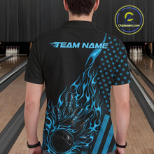 Load image into Gallery viewer, Back view of a male model in a bowling alley wearing a black polo shirt featuring a blue flaming bowling ball knocking down pins.