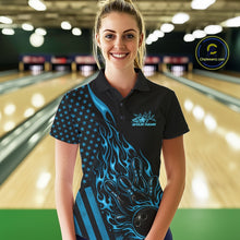 Load image into Gallery viewer, Female model wearing a black bowling polo shirt at a bowling lane with blue flame bowling strike artwork and patriotic details.