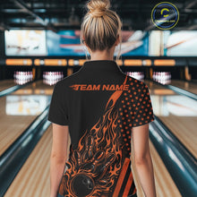 Load image into Gallery viewer, Back view of a female model in a bowling alley wearing a black quarter-zip shirt featuring a flaming bowling strike graphic with patriotic accents.