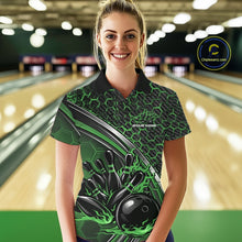 Load image into Gallery viewer, Female model in a bowling lane wearing a black and green polo shirt with honeycomb texture and a flaming bowling strike graphic.