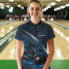 Load image into Gallery viewer, Female model wearing a black and blue bowling quarter zip with honeycomb accents and flaming bowling ball knocking down pins artwork at the bowling lane.