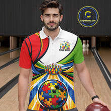 Load image into Gallery viewer, Male model inside a bowling venue wearing a polo shirt, front view highlighting colorful autism bowling lane illustration with puzzle design elements