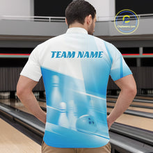 Load image into Gallery viewer, Front view male model at a bowling lane wearing a white and blue quarter zip shirt with bowling ball and pins geometric graphics.