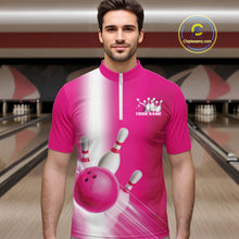 Load image into Gallery viewer, Male model front view in a bowling lane wearing a bowling quarter zip shirt with bowling ball and pins flowing across a pink gradient pattern.