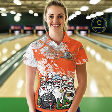 Load image into Gallery viewer, Female model front view at bowling lane wearing white polo with orange and white splatter pattern, cartoon bowling pins and bowling ball surrounded by beer bottles
