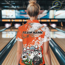 Load image into Gallery viewer, Back view female model at bowling lane wearing white polo with orange and white grunge splatter, cartoon bowling pins and bowling ball surrounded by beer bottles