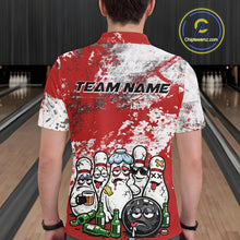 Load image into Gallery viewer, Back view of a male model in a bowling lane wearing a red and white grunge splatter polo shirt featuring playful cartoon bowling action graphics.