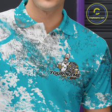 Load image into Gallery viewer, Close-up view of the left chest of a turquoise blue and white grunge splatter polo shirt showing cartoon bowling pins and beer bottle detail artwork.