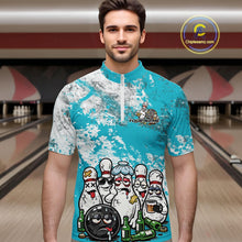 Load image into Gallery viewer, Male model in a bowling lane wearing turquoise blue and white quarter zip shirt, front view showcasing grunge splatter background with playful bowling character graphics