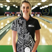 Load image into Gallery viewer, Female model wearing a black and white bowling polo shirt at the bowling lane with tribal swirl bowling graphics and Polynesian-inspired artwork.