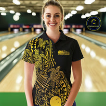 Load image into Gallery viewer, Female model wearing a black and gold bowling polo shirt at the lane with Polynesian-inspired bowling motifs.