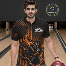 Load image into Gallery viewer, Male model at a bowling lane wearing a black and orange polo shirt with fiery bowling strike artwork and bold patriotic accents.