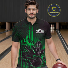 Load image into Gallery viewer, Male model wearing a black and green bowling polo shirt at a bowling lane with fiery bowling strike graphics and patriotic styling.