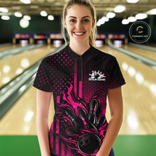 Load image into Gallery viewer, Female model wearing a black and pink bowling quarter-zip shirt at a bowling lane with fiery bowling strike graphics and patriotic styling.