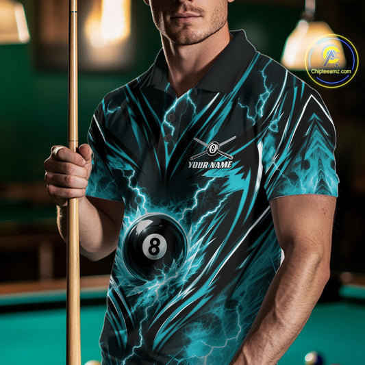 A man wearing a short-sleeve polo shirt with a black and teal lightning-bolt billiards design, holding a pool cue in a dimly lit pool hall. The shirt features a 8-ball graphic and a customizable logo area on the chest.
