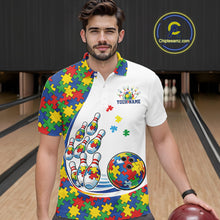 Load image into Gallery viewer, Male model in a bowling lane wearing a white polo shirt, front view showcasing colorful autism-themed bowling strike design with puzzle accents