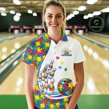 Load image into Gallery viewer, Female model in a bowling lane wearing a white polo shirt, front view showcasing vibrant autism puzzle bowling strike artwork with colorful accents