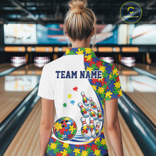 Load image into Gallery viewer, Female model at a bowling lane, back view of white polo shirt featuring autism puzzle bowling strike design with multicolor details