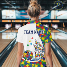 Load image into Gallery viewer, Back view of a female bowler wearing a white quarter-zip shirt, colorful autism puzzle-themed bowling design with dynamic strike elements.