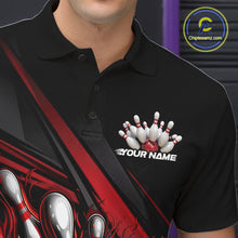 Load image into Gallery viewer, Close-up left chest detail of black bowling polo shirt showcasing red flame bowling ball and pins emblem with geometric stripe accents