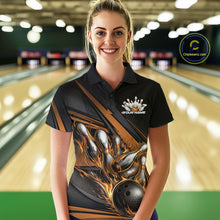 Load image into Gallery viewer, Female model in a bowling lane wearing black polo shirt, front view showcasing gold flame bowling ball hitting pins dynamic artwork