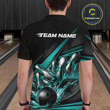Load image into Gallery viewer, Male model in a bowling lane wearing a black polo shirt, back view featuring turquoise flame bowling ball striking pins with abstract geometric stripe design