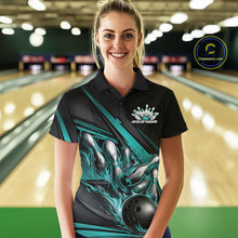 Load image into Gallery viewer, Female model in a bowling alley wearing black polo shirt, front view featuring turquoise flame bowling ball hitting pins geometric design