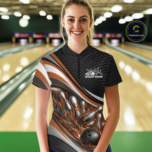 Load image into Gallery viewer, Front view female model wearing black and orange quarter zip bowling shirt in bowling lane, vibrant flame bowling ball and pins design
