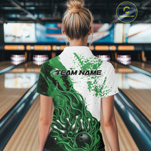 Load image into Gallery viewer, Back view of a female model in a bowling lane wearing a black, green and white flame bowling quarter-zip shirt featuring dynamic bowling strike artwork.