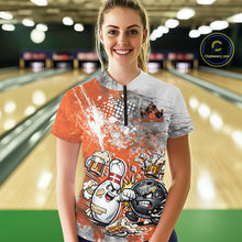Load image into Gallery viewer, Front view of a female model in a bowling lane wearing an orange and white grunge splatter bowling quarter-zip shirt with funny cartoon bowling ball and pin fight scene.
