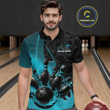 Load image into Gallery viewer, Front view of a male model in a bowling lane wearing a black and blue polo shirt with flaming black bowling ball striking pins and energetic bowling visuals.