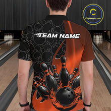 Load image into Gallery viewer, Back view of a male model in a bowling lane wearing a black and orange polo shirt featuring flaming black bowling ball striking pins with bold bowling action graphics.