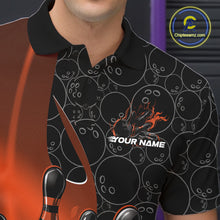 Load image into Gallery viewer, Close-up view of the left chest of a black and orange bowling polo shirt showing gradient bowling ball pattern with flaming bowling strike artwork detail.