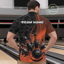 Load image into Gallery viewer, Male model in bowling venue front view wearing black and orange quarter zip shirt featuring dynamic flaming bowling ball and pin impact illustration