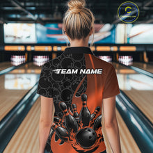 Load image into Gallery viewer, Female model at a bowling lane wearing black and orange quarter zip shirt, back view featuring flaming bowling ball hitting pins with gradient sports styling