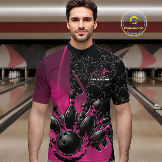 Male model front view at bowling lane wearing black and pink quarter zip shirt with flaming bowling ball pattern and dynamic gradient artwork striking pins