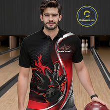 Load image into Gallery viewer, Male model seen from the front in a bowling lane wearing a black and red polo shirt featuring a flame bowling ball striking pins in an energetic action scene.