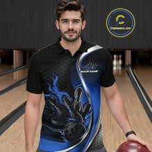 Load image into Gallery viewer, Male model seen from the front in a bowling lane wearing a black and blue polo shirt featuring a flame bowling ball striking pins in a dynamic sports scene.