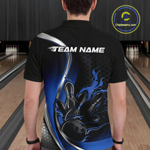 Load image into Gallery viewer, Male model seen from the back in a bowling lane wearing a black and blue polo shirt featuring a flame bowling ball striking pins in a dynamic motion design.