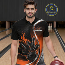 Load image into Gallery viewer, Male model seen from the front in a bowling lane wearing a black and orange polo shirt featuring a flame bowling ball and pins design in a dynamic action scene.